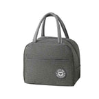 Bolsa Térmica para Marmitas e Dietas Urbanno cinza, formato clássico com alças e bolso frontal com logo "LUNCH BAG DELICIOUS
