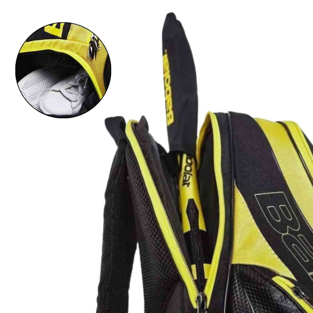 Compartimento de raquete da mochila raqueteira babolat amarela com preto da loja urbanno. Detalhe mostra também o compartimento separado para sapatos.